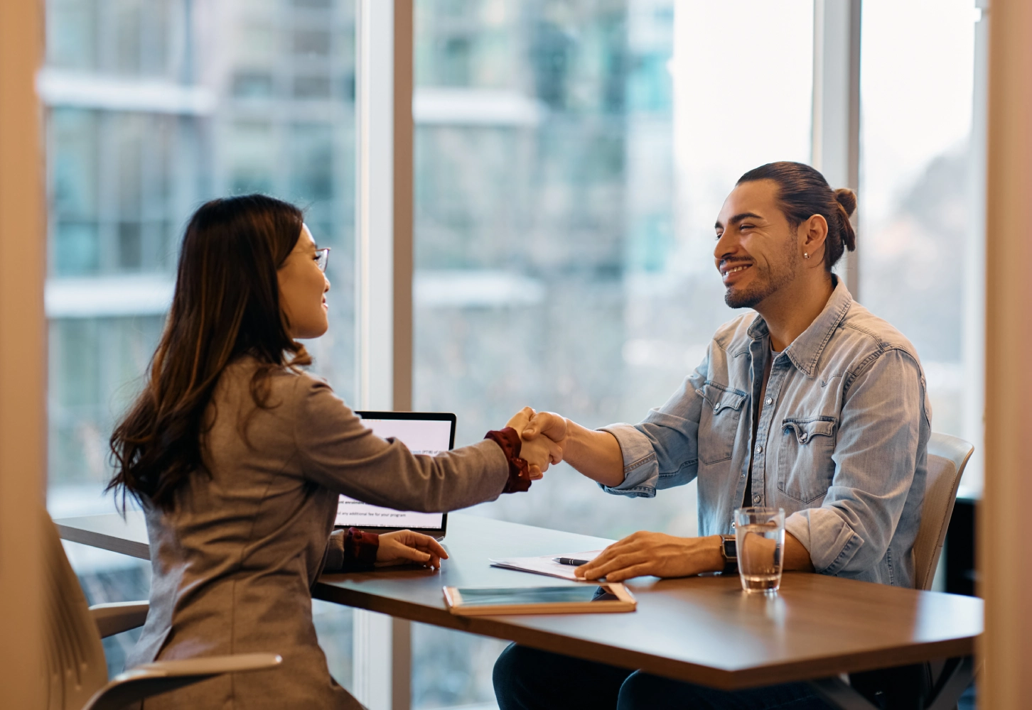 Business colleagues shaking hands, meeting.