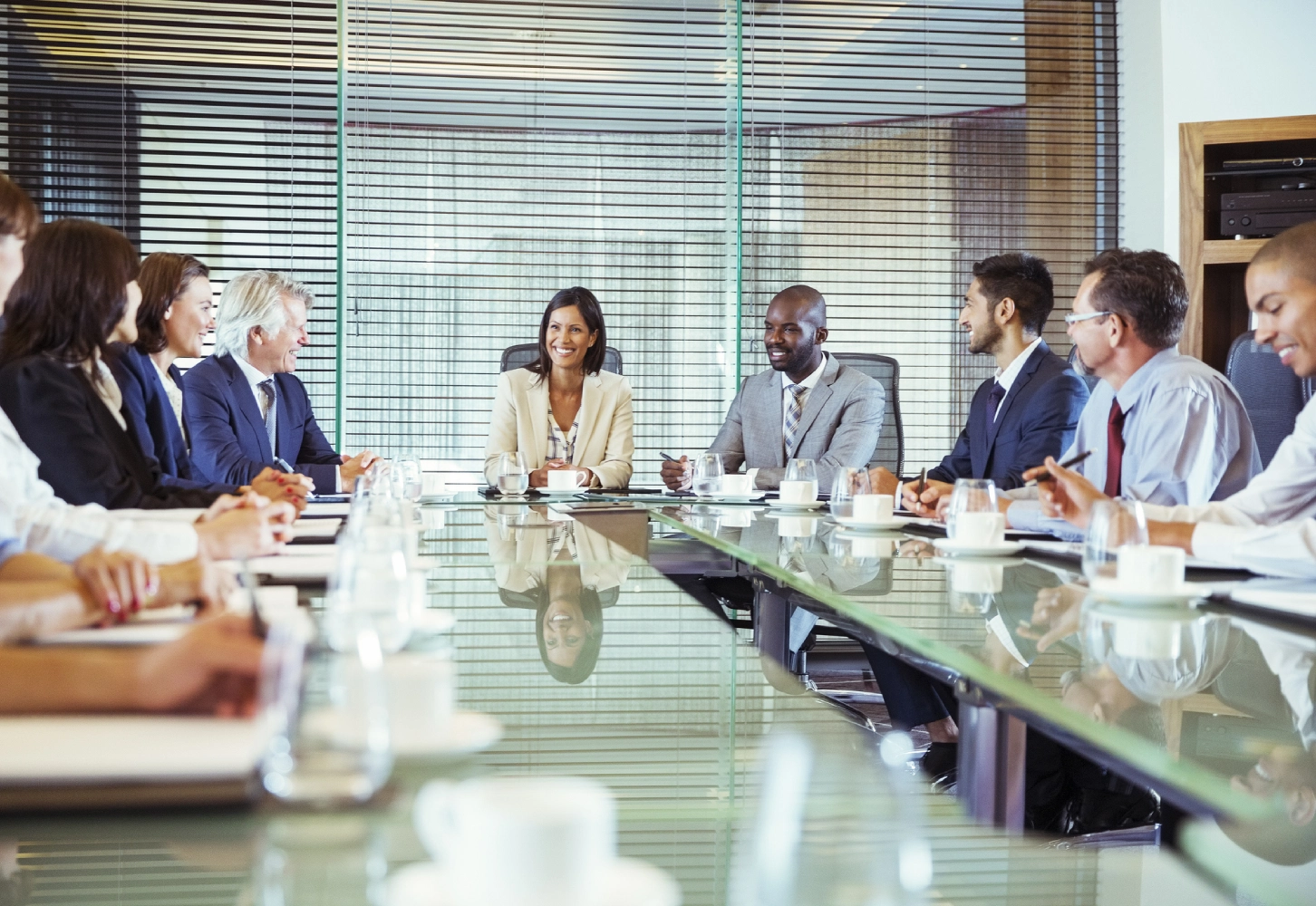 Business team meeting around glass table.