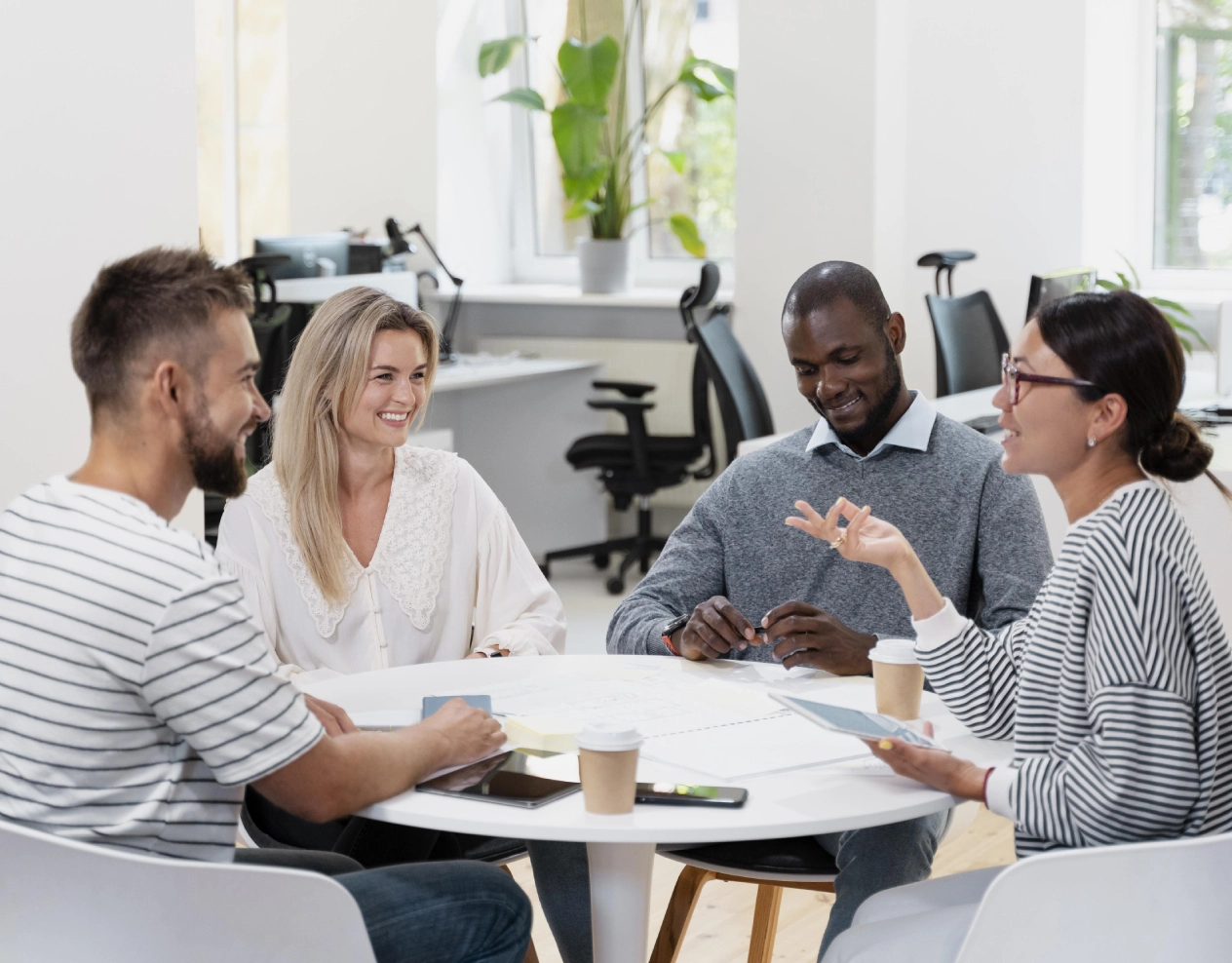 Team meeting around a table, brainstorming.